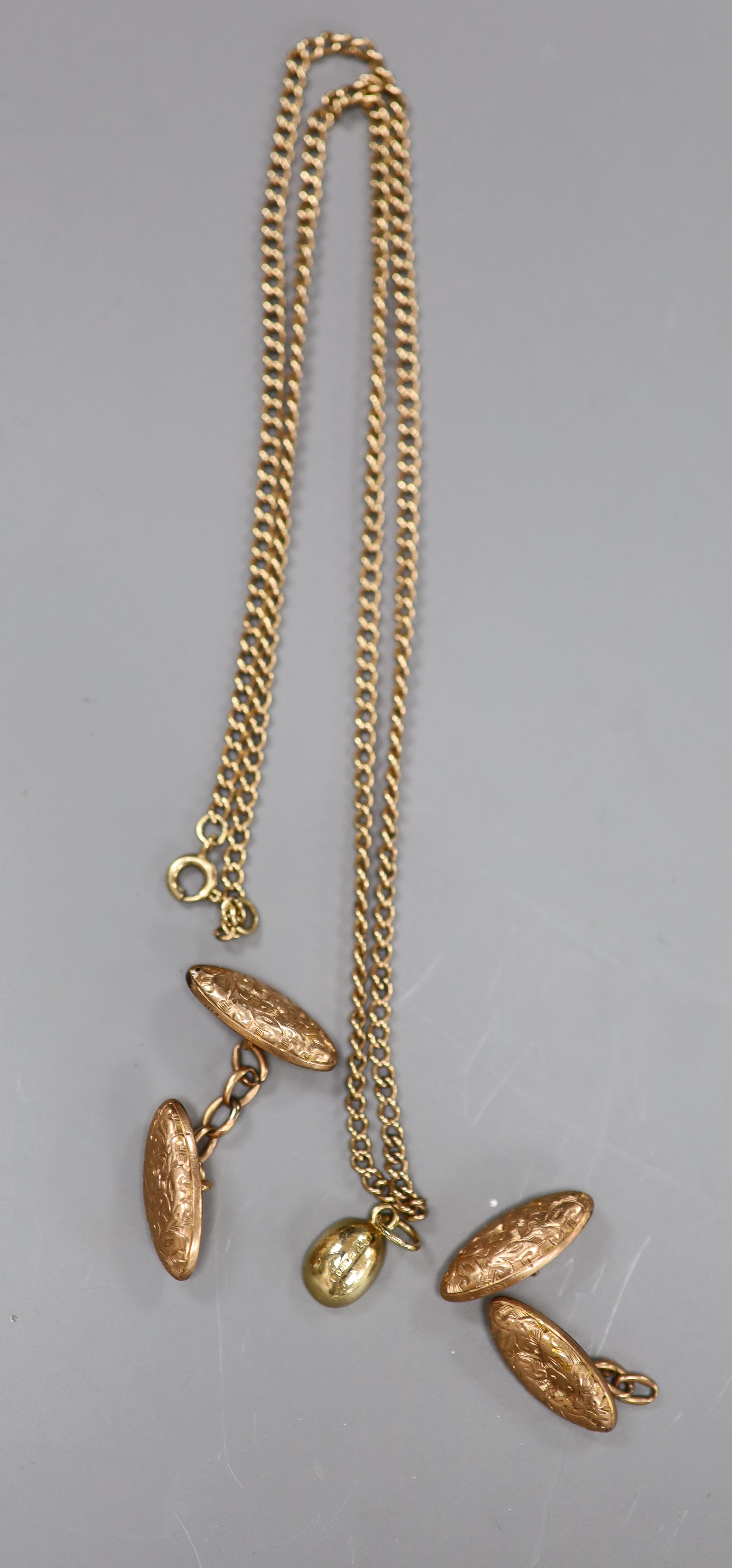 A pair of 9ct oval engraved gold cufflinks (one a.f.), a small 9ct gold bean pendant and a 9ct gold neck chain, gross 14.3g.